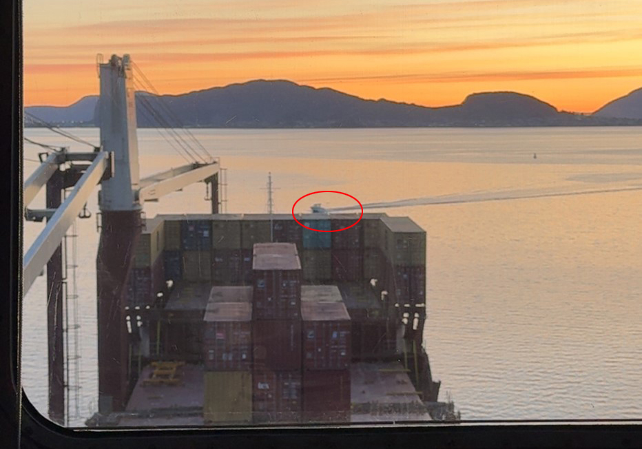 Liten båt kryssar framfor ein stor båt.